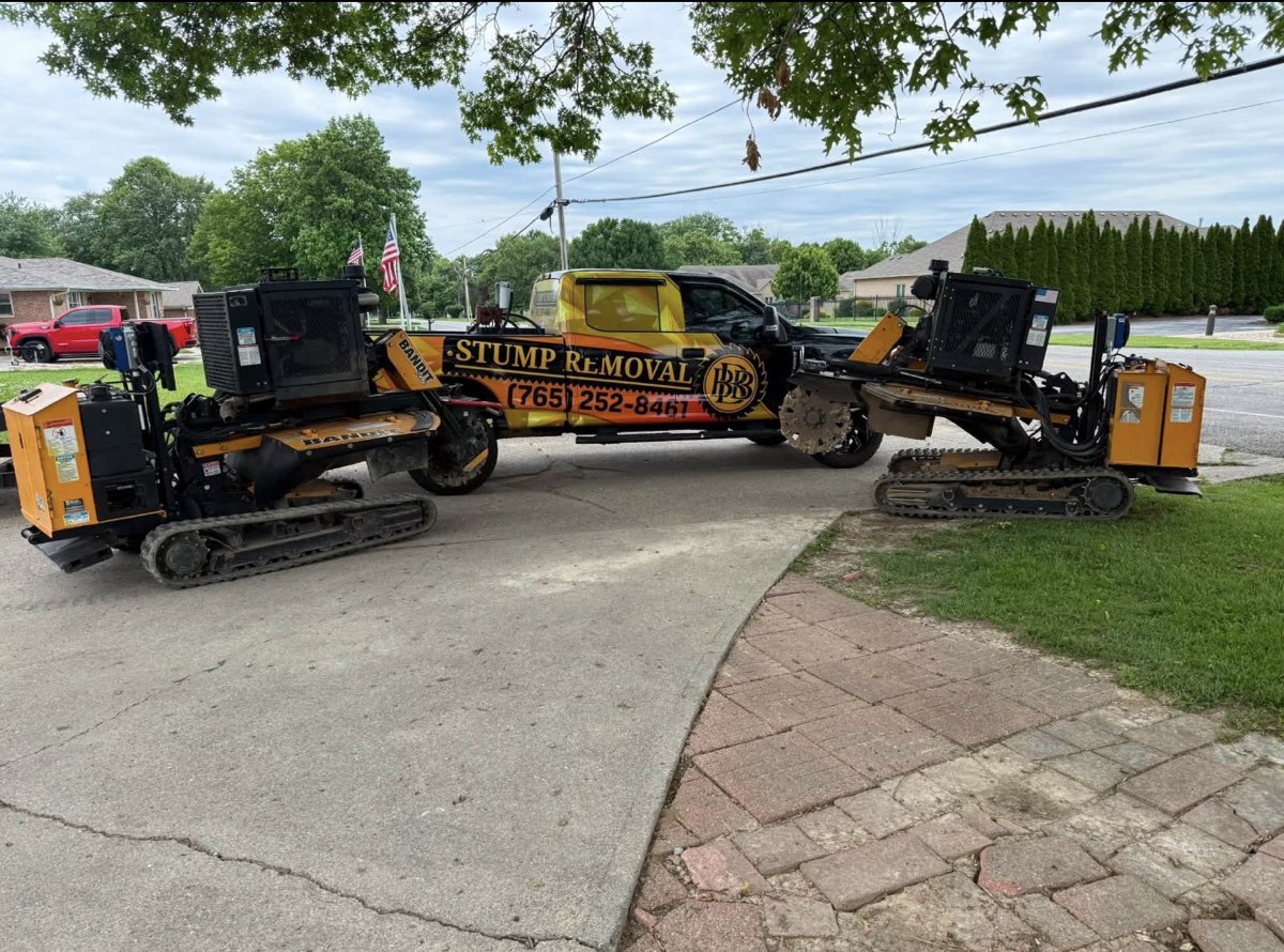 Triple B's wrapped Stump Removal truck flanked by two Bandit remote-controlled stump grinders on a Central Indiana driveway — BBB Stump Removal & Property Maintenance